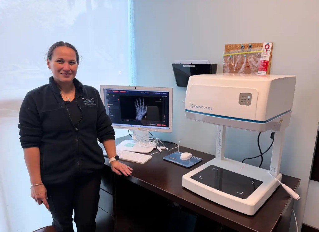 Judith Arroyo of the Badia Hand to Shoulder Center in South Florida takes receipt of the Adaptix Ortho350