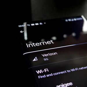 Close-up of a smartphone screen displaying internet connection details with Verizon 5G and Wi-Fi options.